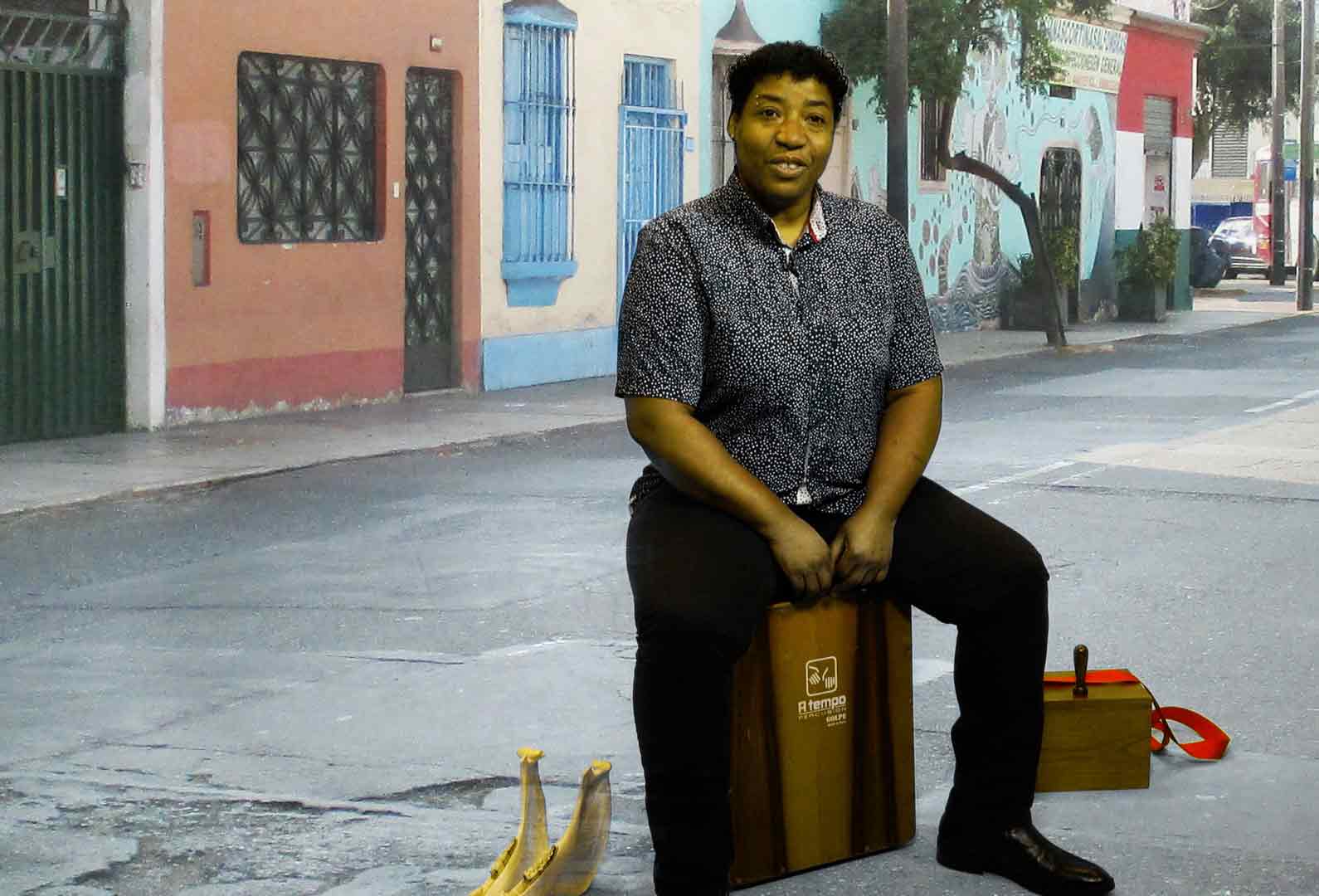 Peta Robles plays cajon on a street in Lima, Peru