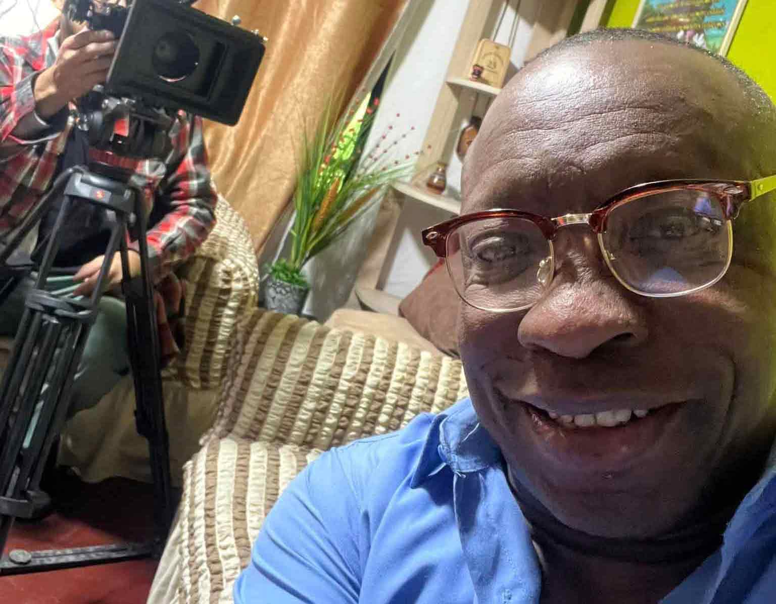 Freddy "Huevito" Lobatón in home with camera behind